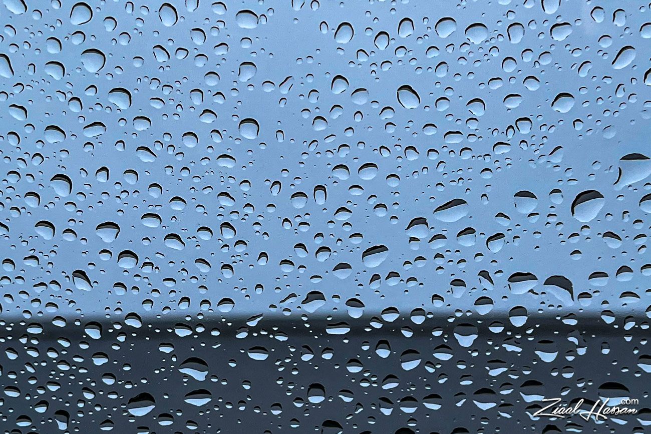 Soothing Raindrops on Glass with Moody Blue Tones - Dr. Zia-al-Hassan Photography