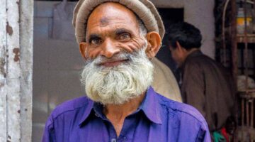 Happy Poor Old Man Standing By The Roadside In Murree