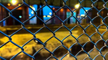 Urban Night Perspective Through Chain Link Fence - Dr. Zia-al-Hassan Photography