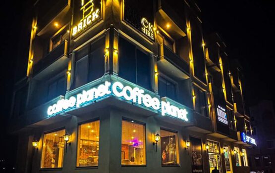 Modern Coffee Planet Building with Warm Night Lighting - Dr. Zia-al-Hassan Photography