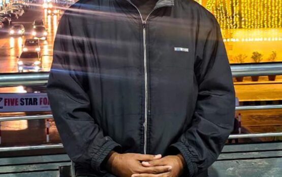 Portrait of Zeeshan Overlooking a Vibrant Night Cityscape - Dr. Zia-al-Hassan Photography